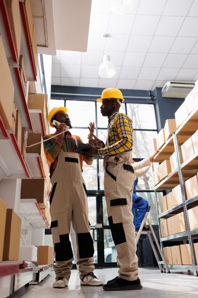 warehouse-employees-talking-with-stock-supply-manager-on-phone-682x1024