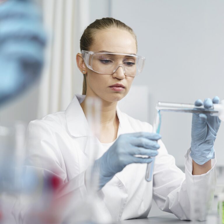 front-view-female-researcher-laboratory-with-test-tubes-safety-glasses-768x768